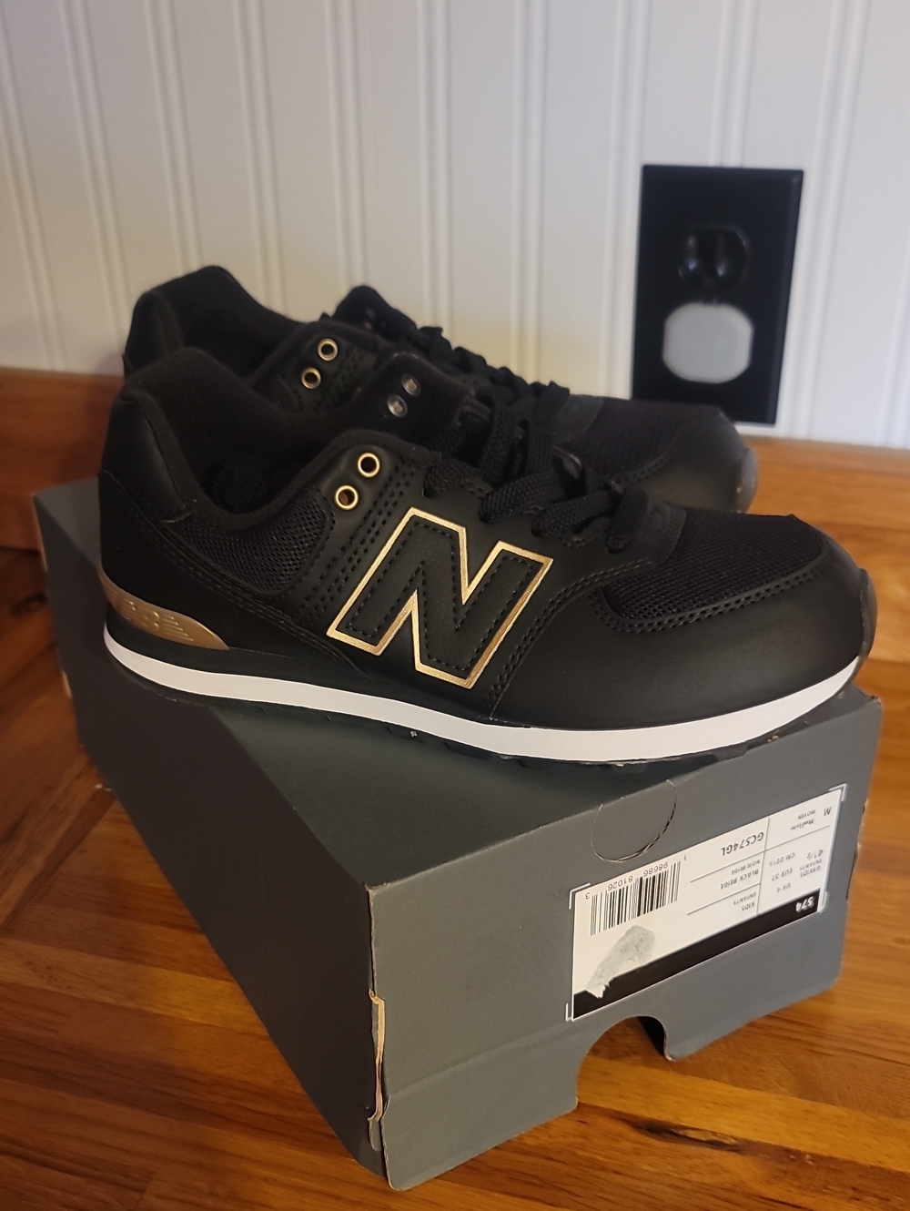 New Balance Kid’s Black with Gold Accent Sneakers
